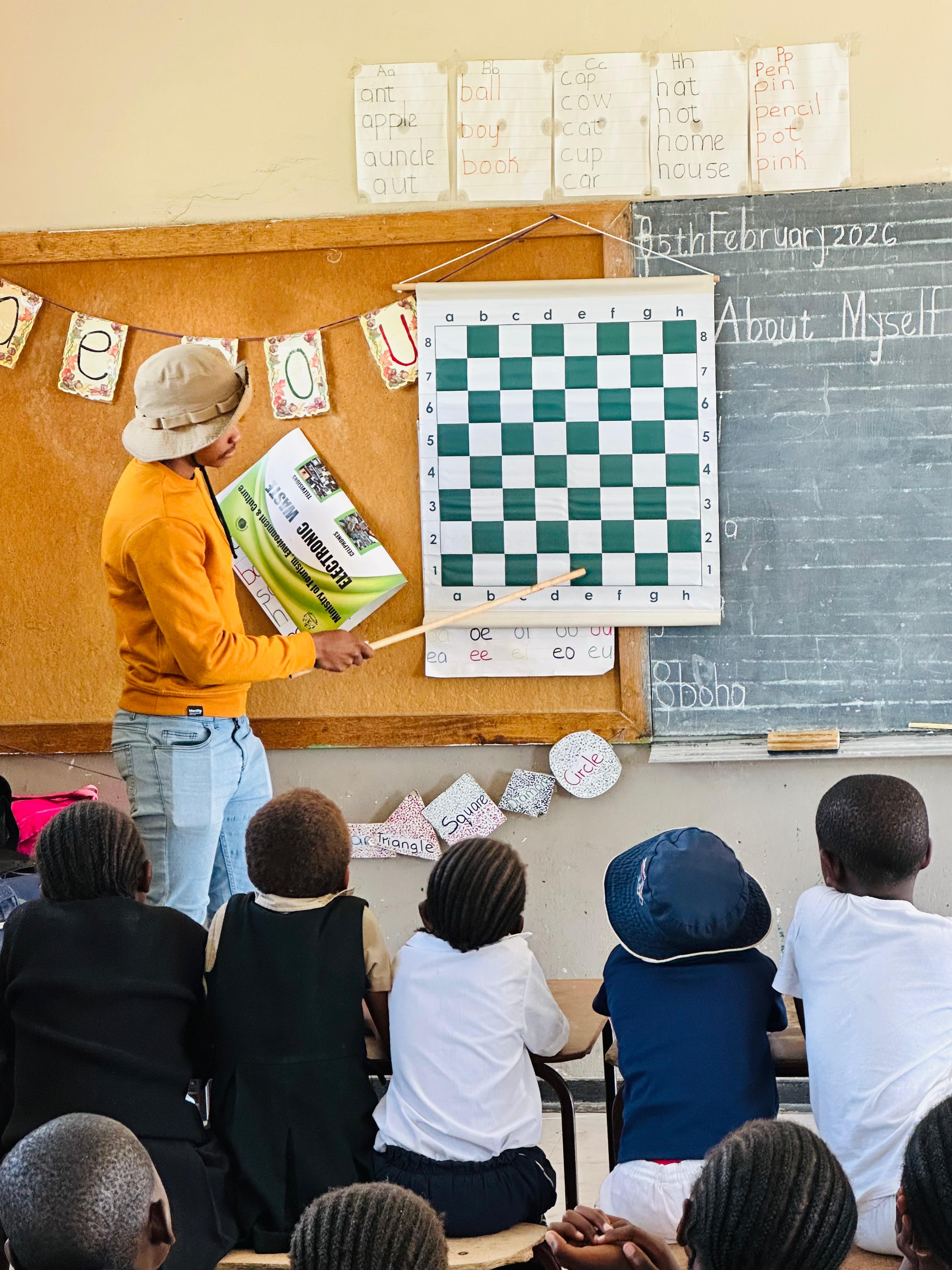 Coach Motalingoane of Monafils Institute with Hoohlo primary school students